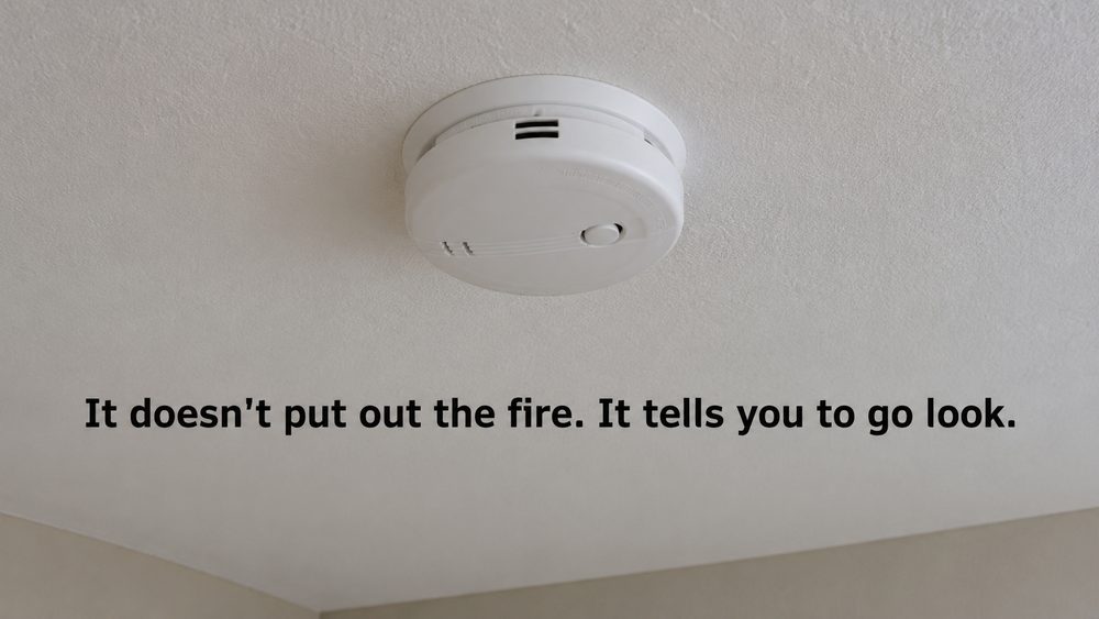 A ceiling smoke alarm, it does not put out the fire, it tells you to go look