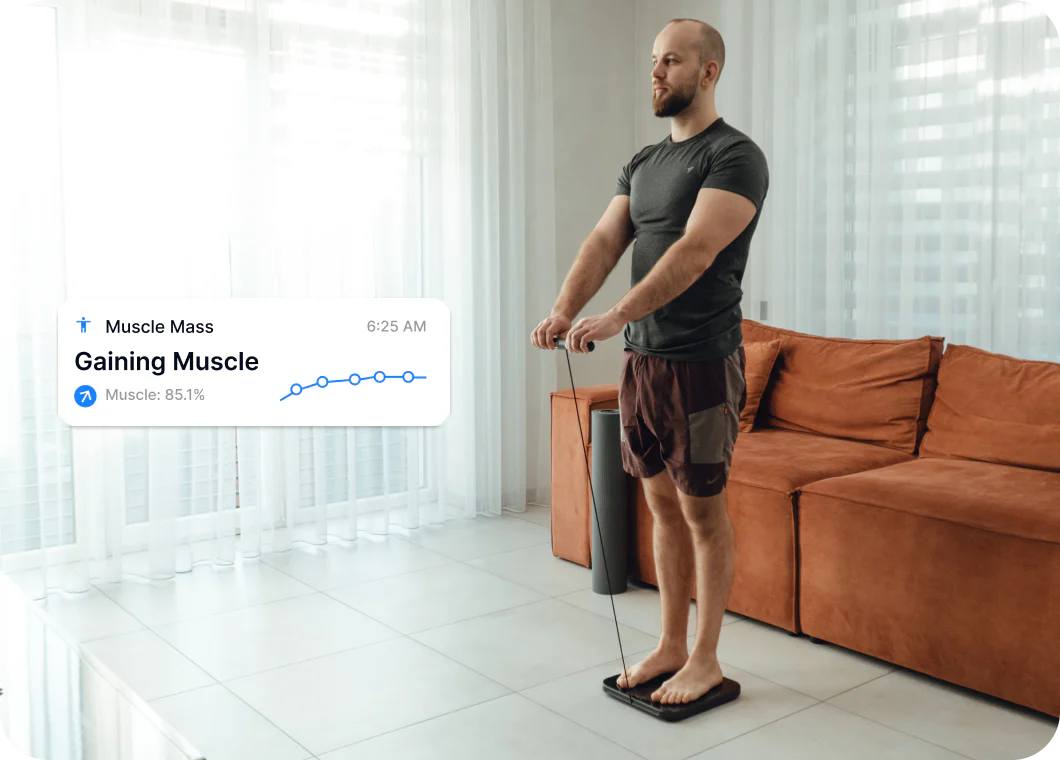 A man scanning at home while the app reports gaining muscle
